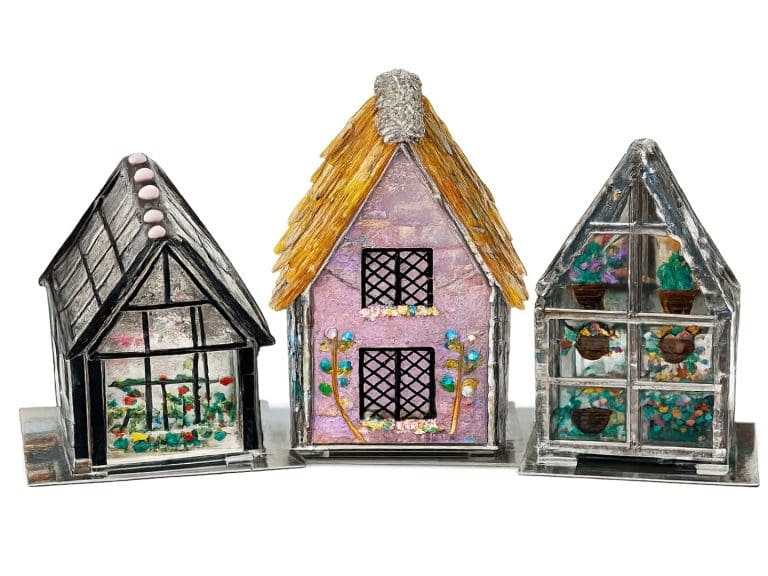 Student-made copper foil stained glass greenhouse and candy house with colourful UV resin accents at Teach Me Courses in New Romney, Kent.