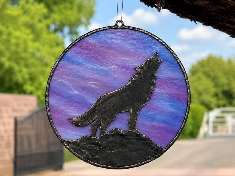 Copper foil overlay glass artwork featuring a black patina wolf silhouette on coloured stained glass, created at Teach Me Courses in New Romney.